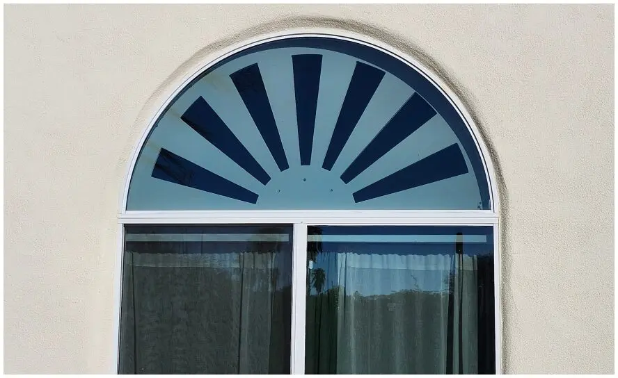 Arched window with sunburst pattern.